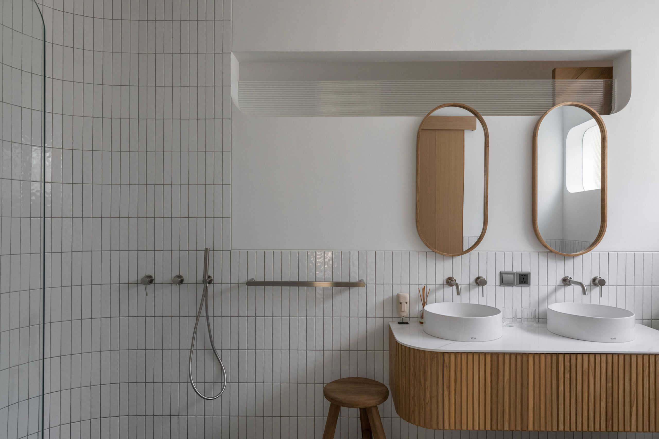 Modern bathroom with double sink and wooden accents at Jipsi Villas Bali