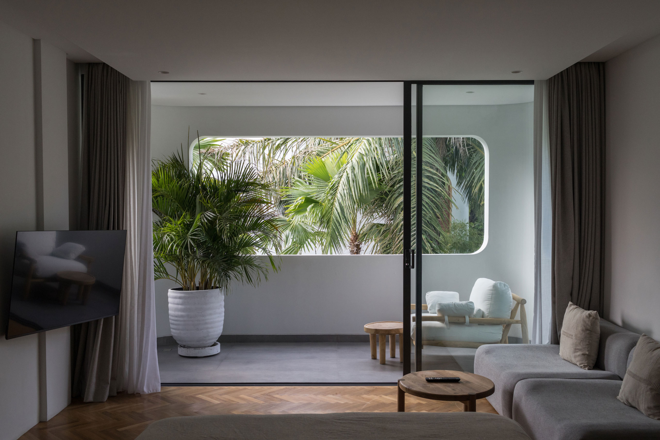 Modern bedroom with balcony and tropical garden view at Jipsi Villas Bali