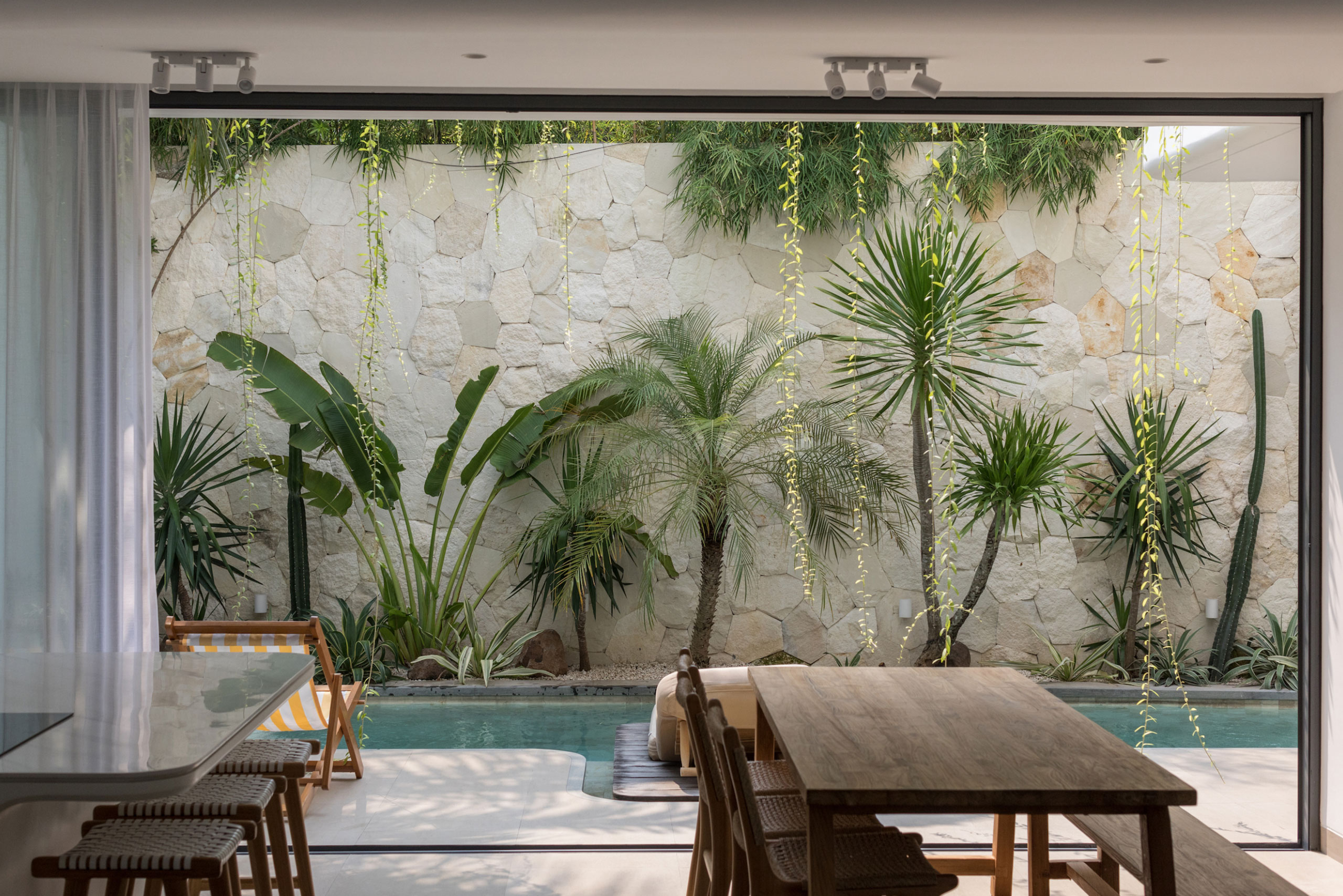 Dining area with tropical garden and pool view at Jipsi Villas Bali