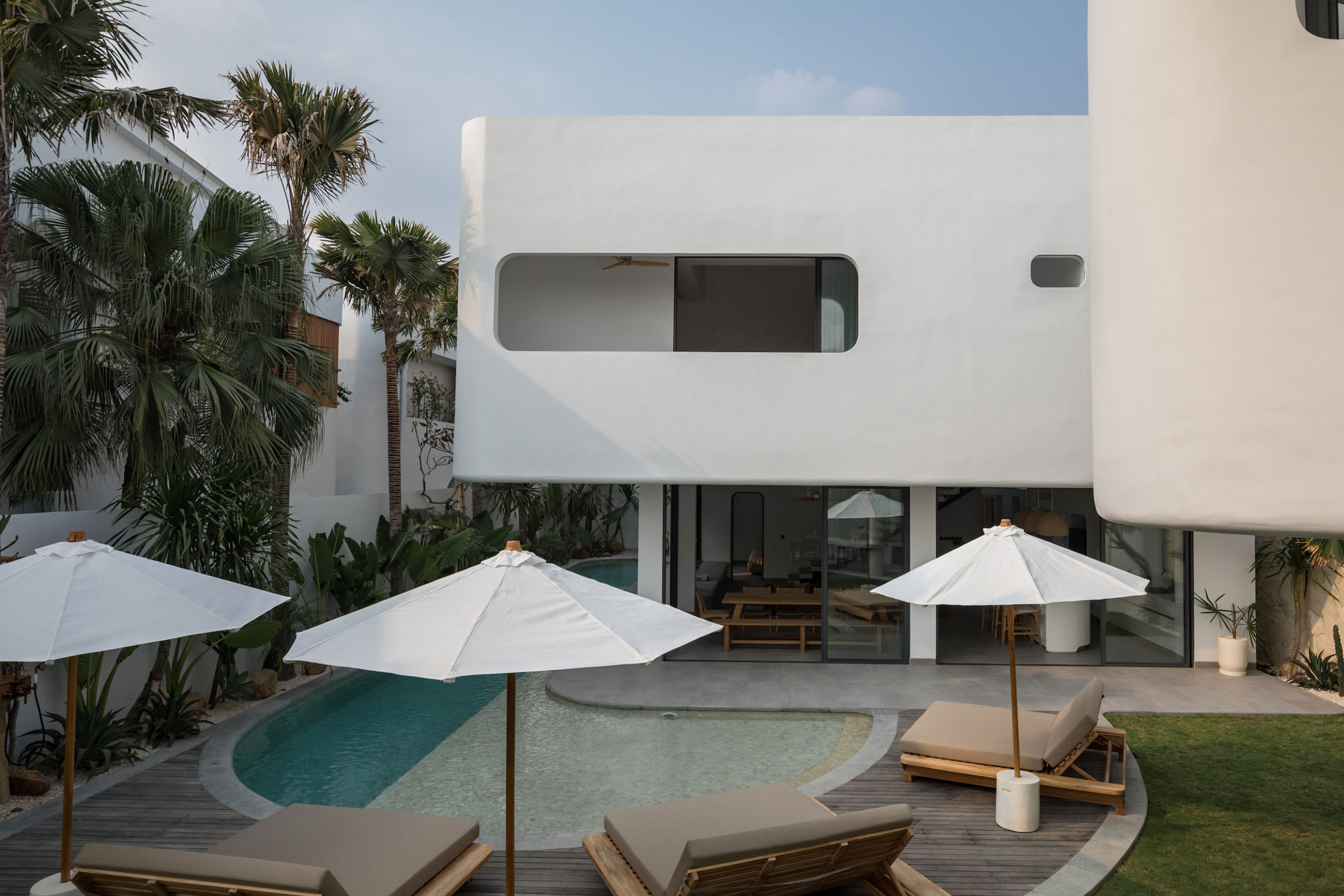 Modern villa exterior with private pool and sun loungers at Jipsi Villas Bali