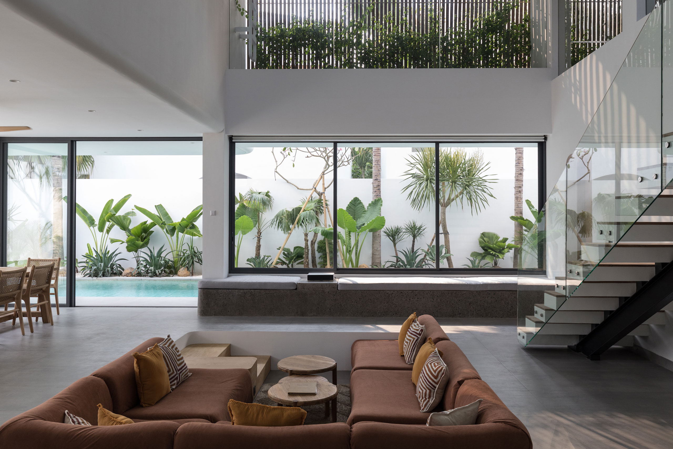 Bright open living area with pool and tropical garden view at Jipsi Villas Bali