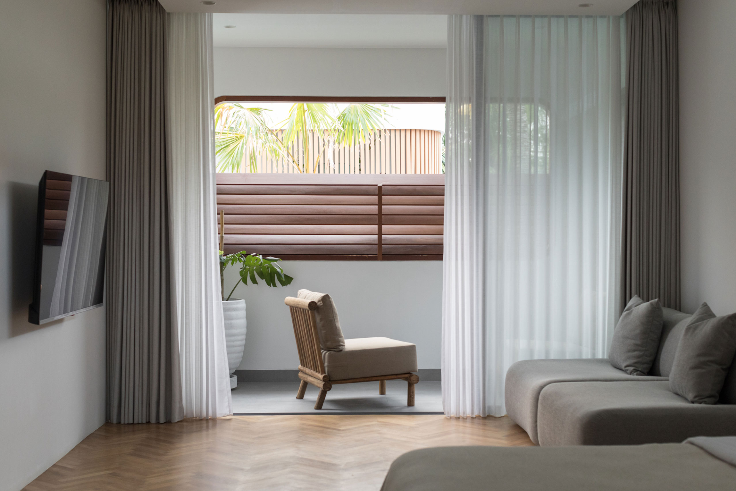 Modern living area with sofa and balcony view at Jipsi Villas Bali.