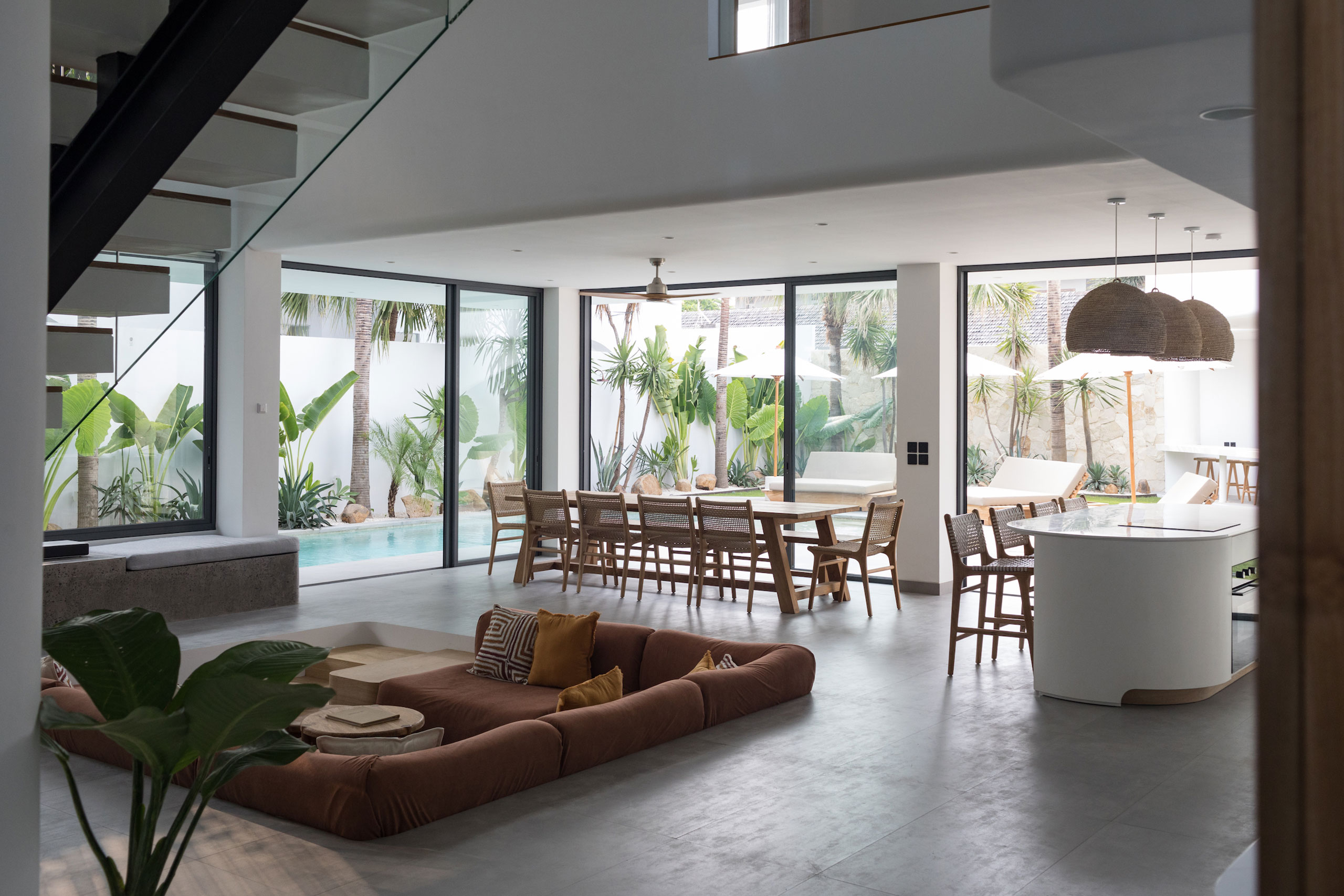 Spacious open-plan living and dining area with pool view at Jipsi Villas Bali