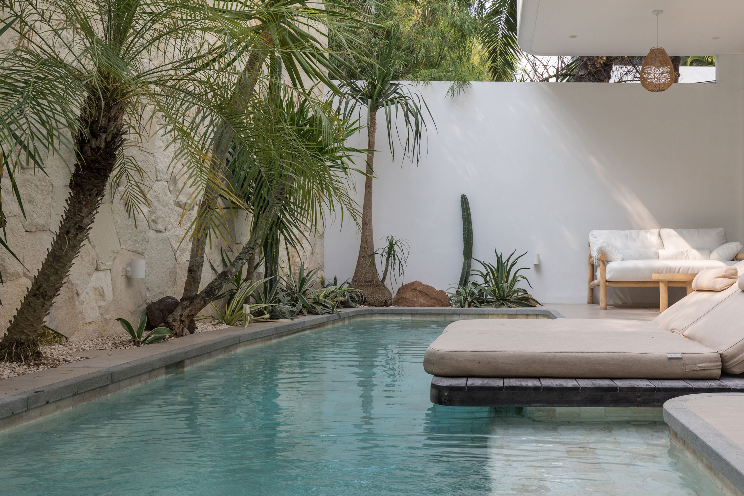 Private pool with tropical plants and lounge area at Jipsi Villas Bali