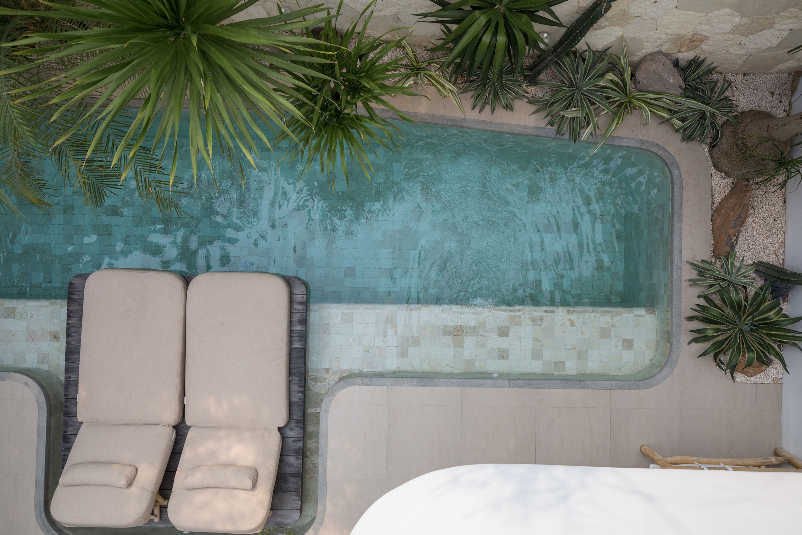 Top view of private swimming pool with tropical plants at Jipsi Villas Bali