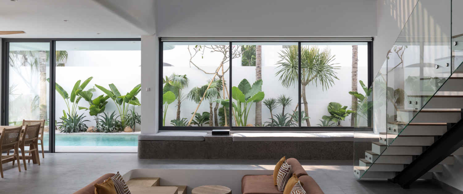 Bright open living area with pool and tropical garden view at Jipsi Villas Bali