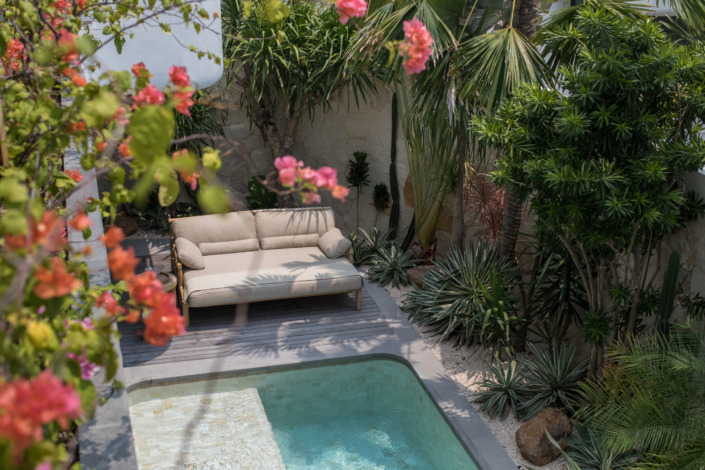 Private pool and tropical garden view with lounge chair at Jipsi Villas Canggu Bali